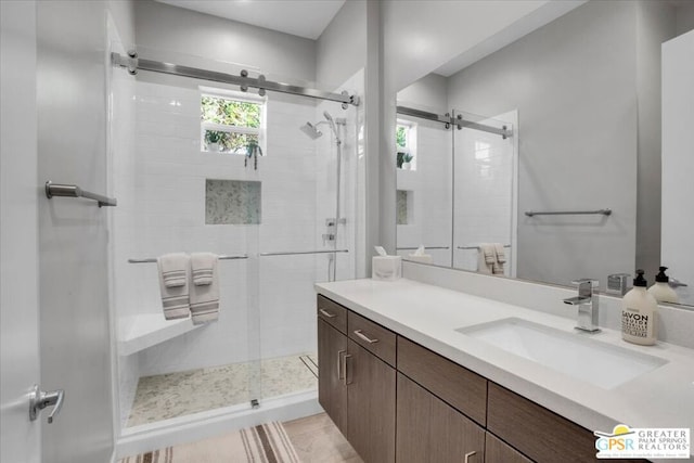 bathroom with tile patterned floors, vanity, and a shower with shower door