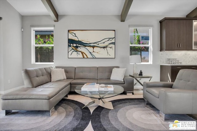 living room featuring beam ceiling and a wealth of natural light