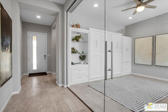 foyer featuring ceiling fan