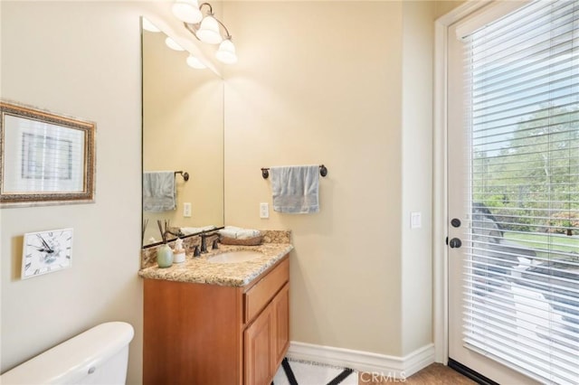 bathroom featuring vanity and toilet