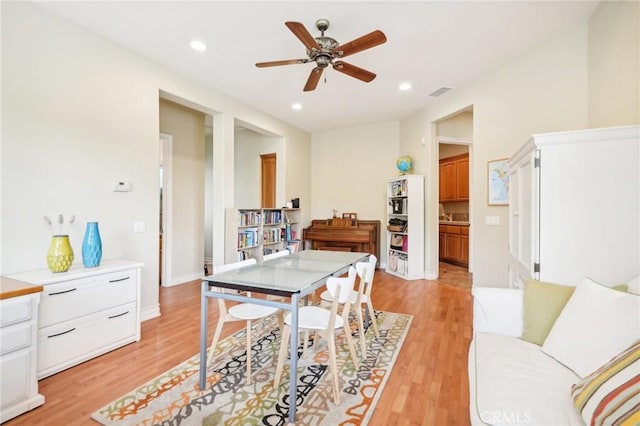 dining space featuring ceiling fan and light wood-type flooring