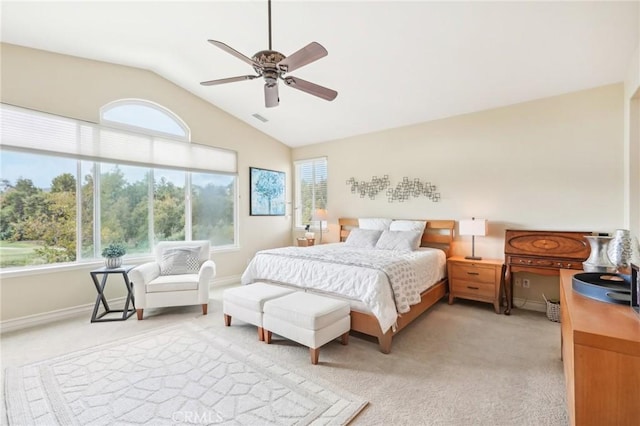 bedroom with multiple windows, light colored carpet, ceiling fan, and lofted ceiling