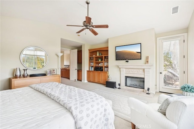 carpeted bedroom with ceiling fan, access to outside, and multiple windows