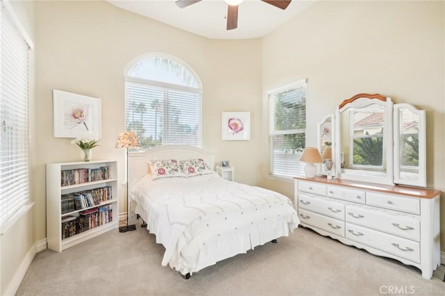 bedroom featuring light carpet and ceiling fan