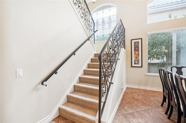 staircase featuring tile patterned flooring and plenty of natural light