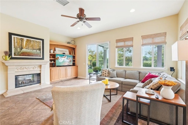 tiled living room featuring ceiling fan