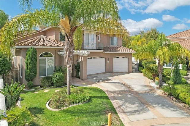 mediterranean / spanish-style home with a front yard and a garage