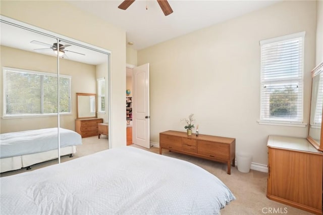 bedroom featuring light carpet and ceiling fan