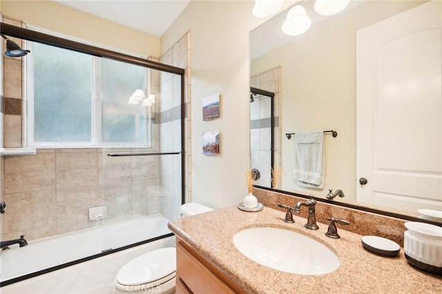 full bathroom with shower / bath combination with glass door, vanity, and toilet