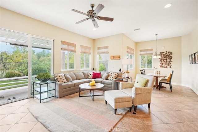 living room featuring ceiling fan, a healthy amount of sunlight, and light tile patterned floors