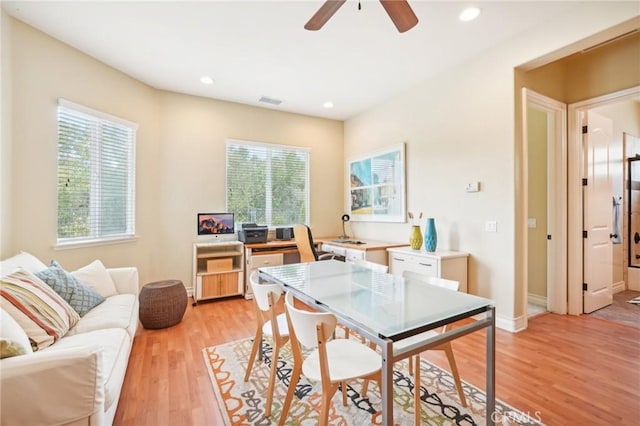 dining area with light hardwood / wood-style floors and ceiling fan