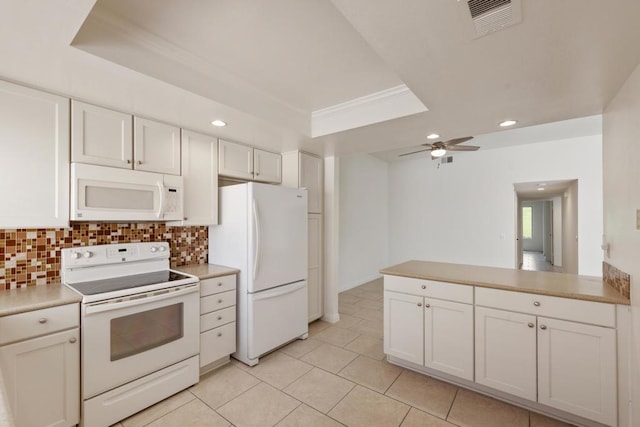 kitchen with ceiling fan, white appliances, a tray ceiling, decorative backsplash, and white cabinets