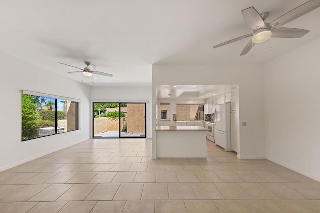 unfurnished living room with ceiling fan and light tile patterned flooring