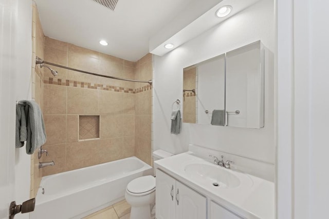 full bathroom featuring tile patterned floors, toilet, vanity, and tiled shower / bath