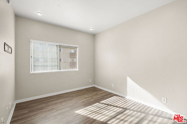 empty room with hardwood / wood-style flooring