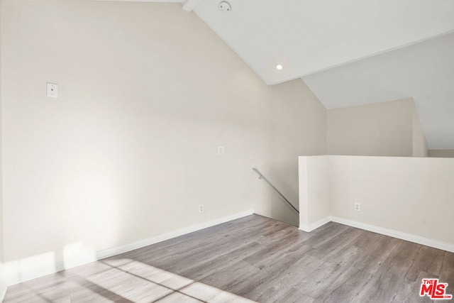 empty room featuring light hardwood / wood-style floors and high vaulted ceiling