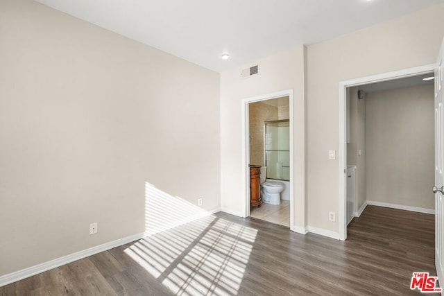 unfurnished room with dark hardwood / wood-style flooring