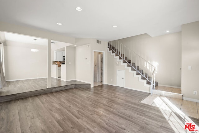 interior space with washer / clothes dryer and light hardwood / wood-style floors