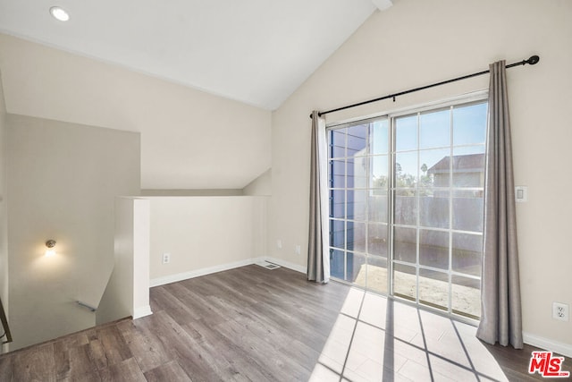 additional living space with hardwood / wood-style floors and high vaulted ceiling