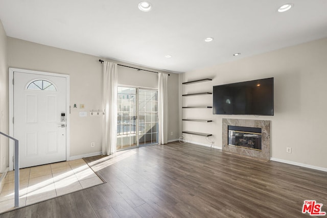 unfurnished living room with wood-type flooring and a fireplace