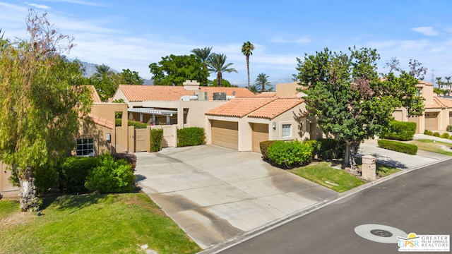 mediterranean / spanish house with a front yard and a garage