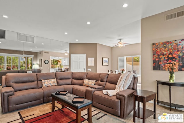 living room with ceiling fan and plenty of natural light