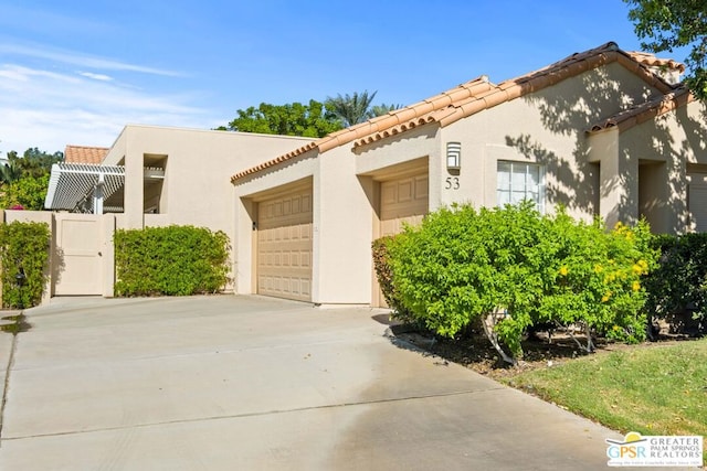 mediterranean / spanish home with a garage