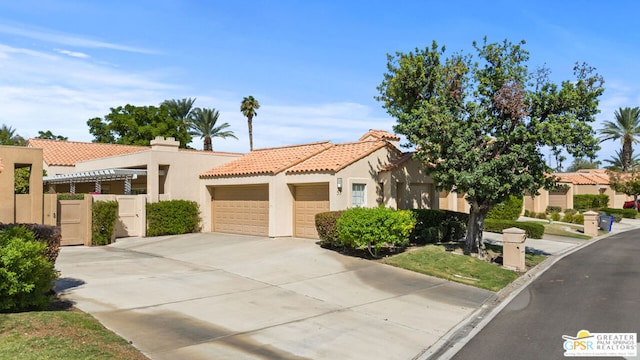 mediterranean / spanish home with a garage