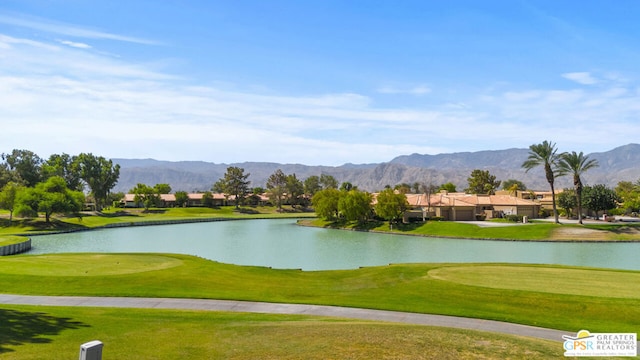 view of home's community with a water and mountain view and a lawn