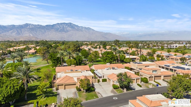 drone / aerial view featuring a water and mountain view