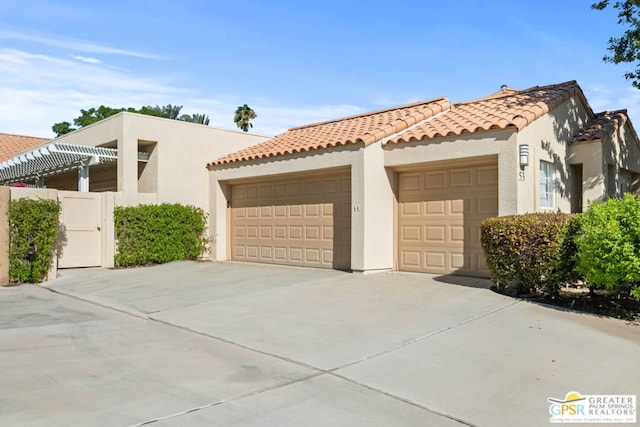 mediterranean / spanish-style house with a garage