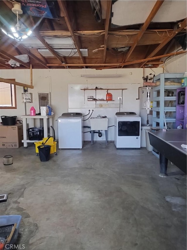 garage featuring secured water heater, white refrigerator, sink, and washer / clothes dryer