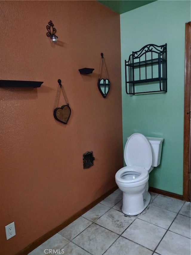 bathroom featuring tile patterned flooring and toilet