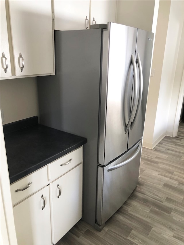 details featuring fridge with ice dispenser and white cabinetry