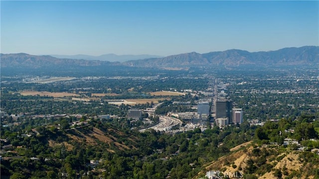 property's view of city with a mountain view