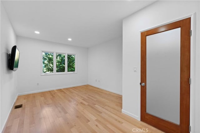 unfurnished room featuring light hardwood / wood-style floors