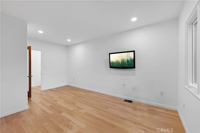 spare room featuring light hardwood / wood-style flooring