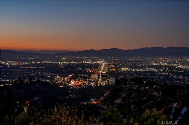 property's view of city featuring a mountain view