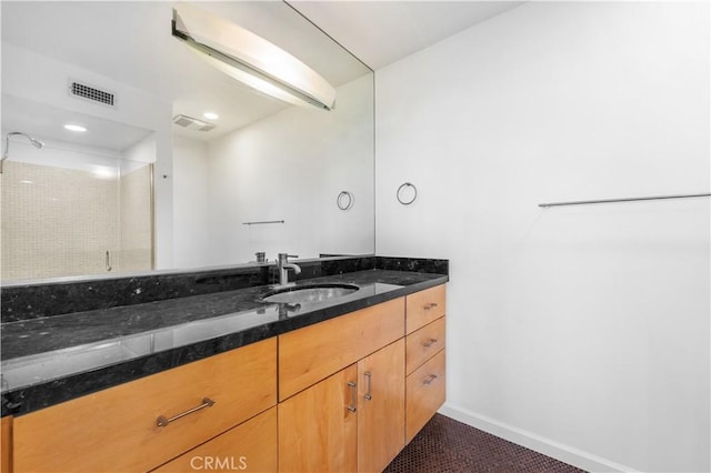 bathroom with vanity, tile patterned flooring, and a shower