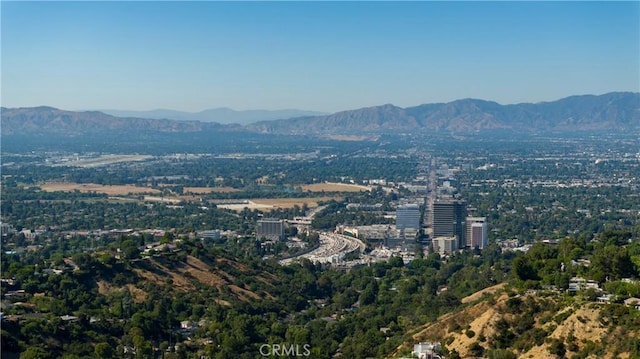 exterior space with a mountain view and a view of city