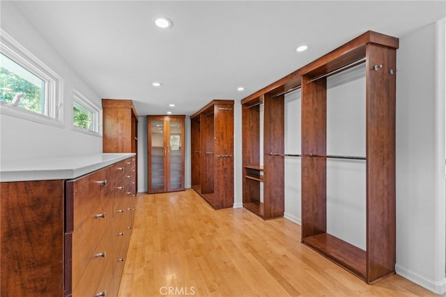 walk in closet featuring light wood-style flooring