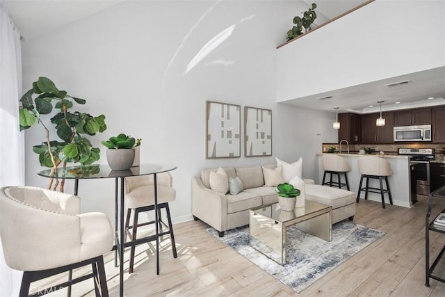 living area with light wood finished floors and baseboards