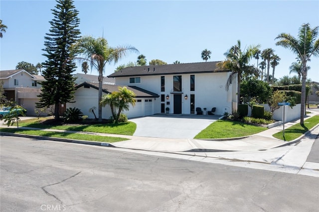 view of front facade featuring a front yard and a garage