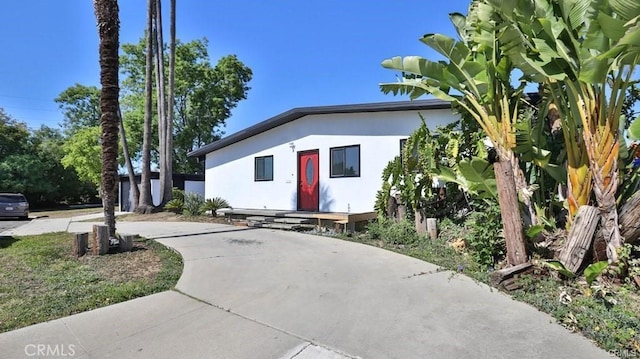 view of front facade featuring concrete driveway and stucco siding