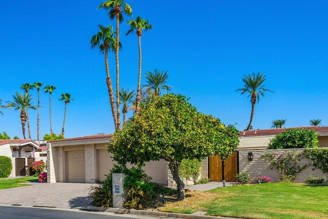 view of front of property with a garage and a front lawn