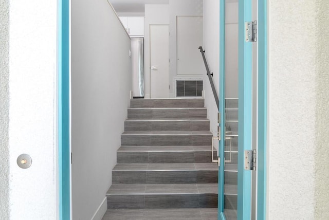 staircase featuring wood-type flooring