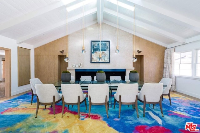 dining space with vaulted ceiling with beams and wood walls