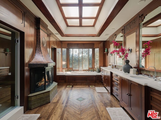 bathroom with vanity, a bathtub, and a raised ceiling