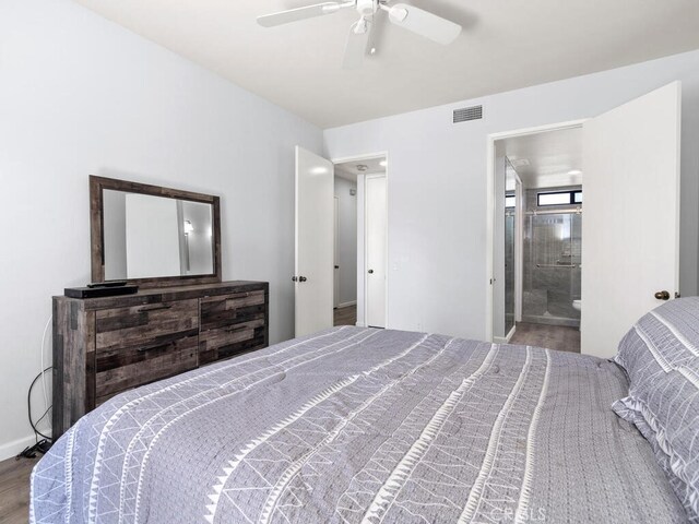 bedroom with ceiling fan, hardwood / wood-style floors, and ensuite bathroom