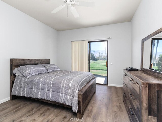 bedroom featuring ceiling fan, dark wood-type flooring, and access to exterior